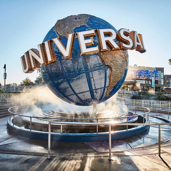 A large globe with the word "UNIVERSAL" on it, surrounded by a water feature.
