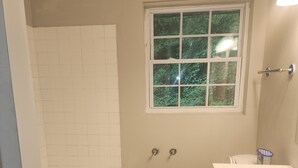 A bathroom with a bathtub, toilet, and sink.