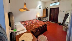A bedroom with a bed, a desk, a chair, a wardrobe, a mirror, and a door. - Nomads Hideaway Near Matara Railway Stat (Matara)