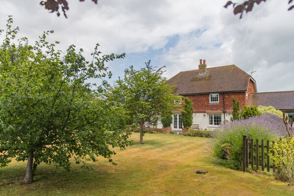 A brick house with a well-maintained lawn and a wooden fence. - St Mary's House, Worth, Deal, Kent (Deal)