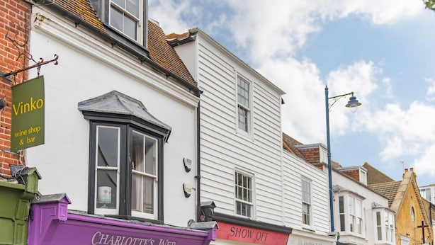 A row of white buildings with shop fronts, including 'Vinko' and 'Charlotte's Web'. - Harbour Master, Whitstable, Kent (Whitstable)