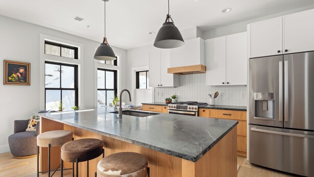 A modern kitchen with a large island, stainless steel appliances, and pendant lighting. - Upscale 4Bdrm Getaway with Hot Tub, Near Stowe Village & Trails (Stowe)