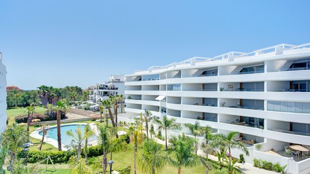 A modern hotel with multiple balconies, a swimming pool, and lush greenery. - Ref. 567641 (Motril)