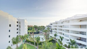 A modern multi-story residential building with balconies, a swimming pool, and lush greenery. - Ref. 567641 (Motril)