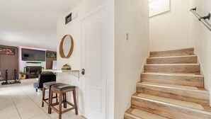 A staircase with wooden steps leading to a landing. - Wall Street Retreat - Modern , Luxury, Near Beach! (Port Orange)