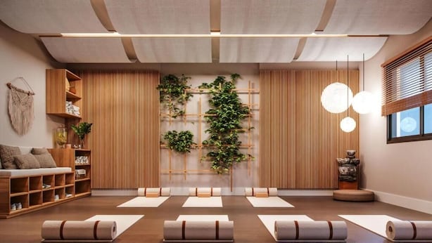 A modern spa room with wooden paneling, a wall-mounted plant, and a seating area with mats. - Studio completo Vl Olimpia Be my Guest (São Paulo)
