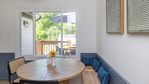 A dining area with a round table, chairs, a bench, and a window with a view of greenery outside. - 4BR Pineville Retreat - Private Pool - Fire Pit - Near Carowinds & Charlotte (Pineville)