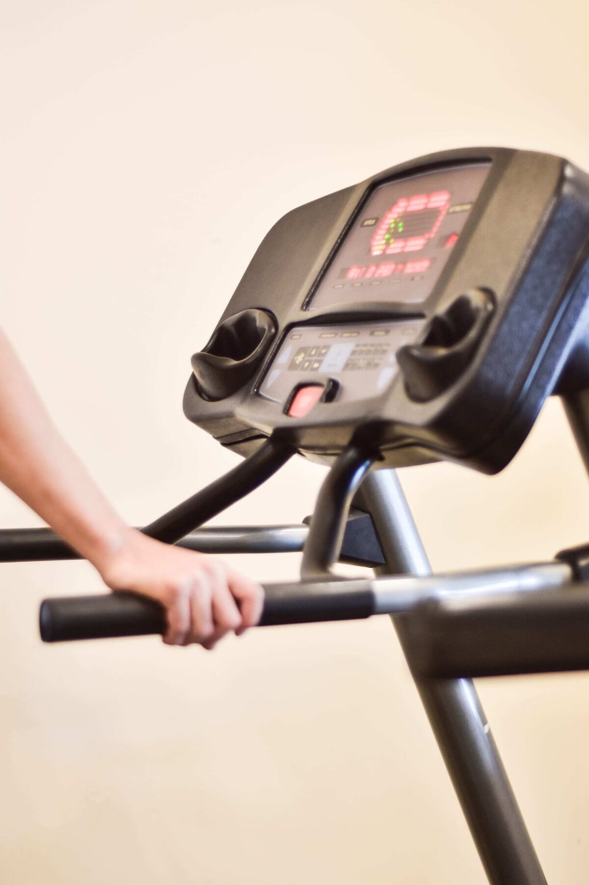 A treadmill with a digital display and control panel.
