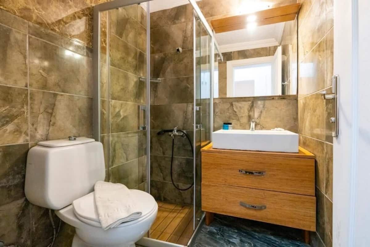 Shower, hair dryer, slippers, towels