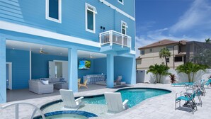 A pool area with lounge chairs, a bar, and a covered seating area with a TV. - Anchors Down (Fort Myers Beach)