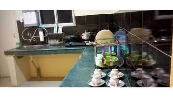 Fridge, electric kettle, cookware/dishes/utensils