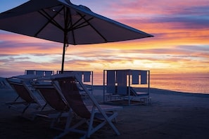 On the beach, sun-loungers, beach towels