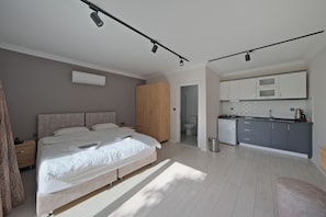 Studio Suite, Pool View | In-room safe, desk, laptop workspace, iron/ironing board