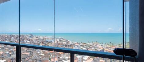 A cityscape with a view of the sea through a window.