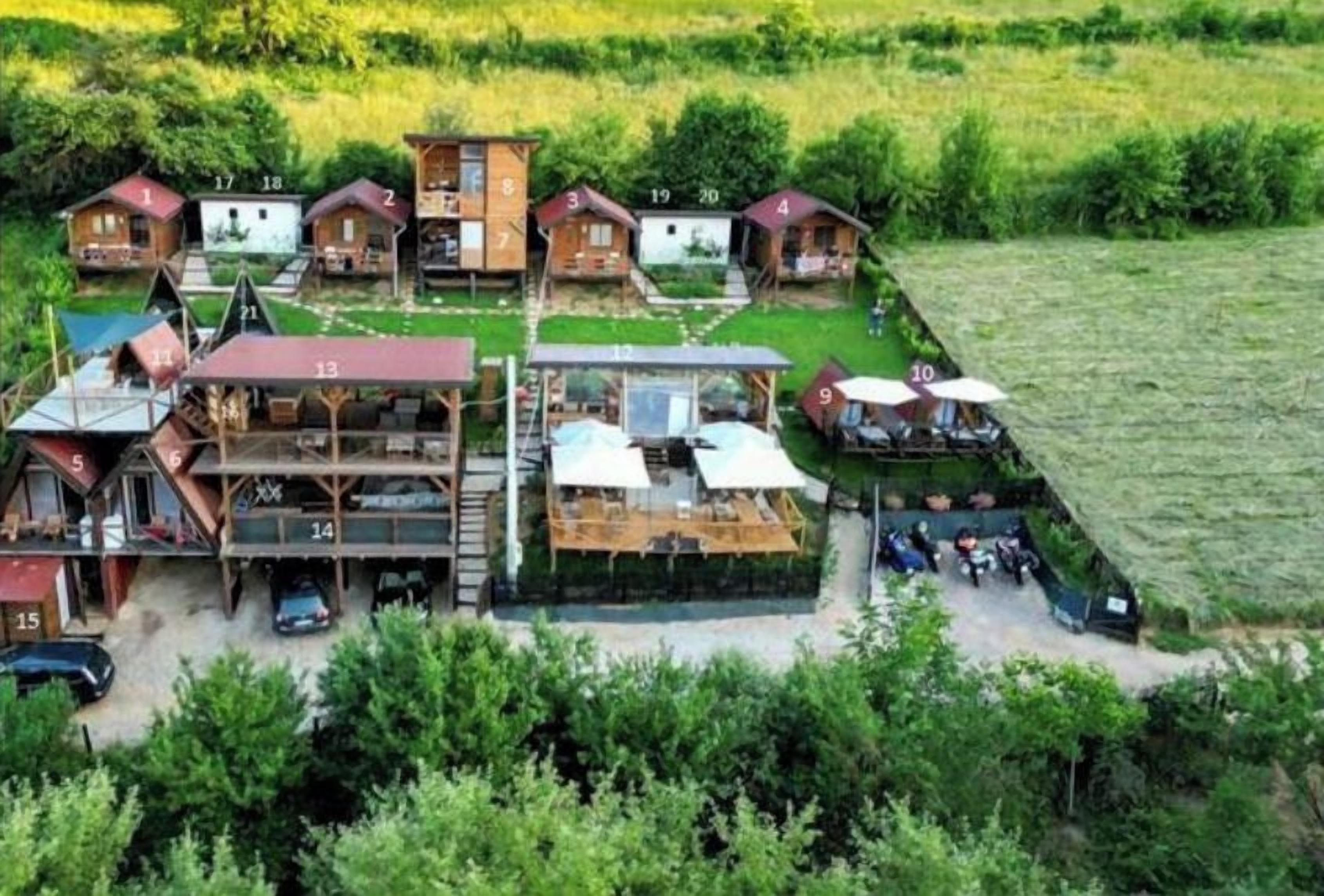 Ein Grundriss einer Ferienanlage mit mehreren Bungalows, einer Gemeinschaftsküche und einem Essbereich.
