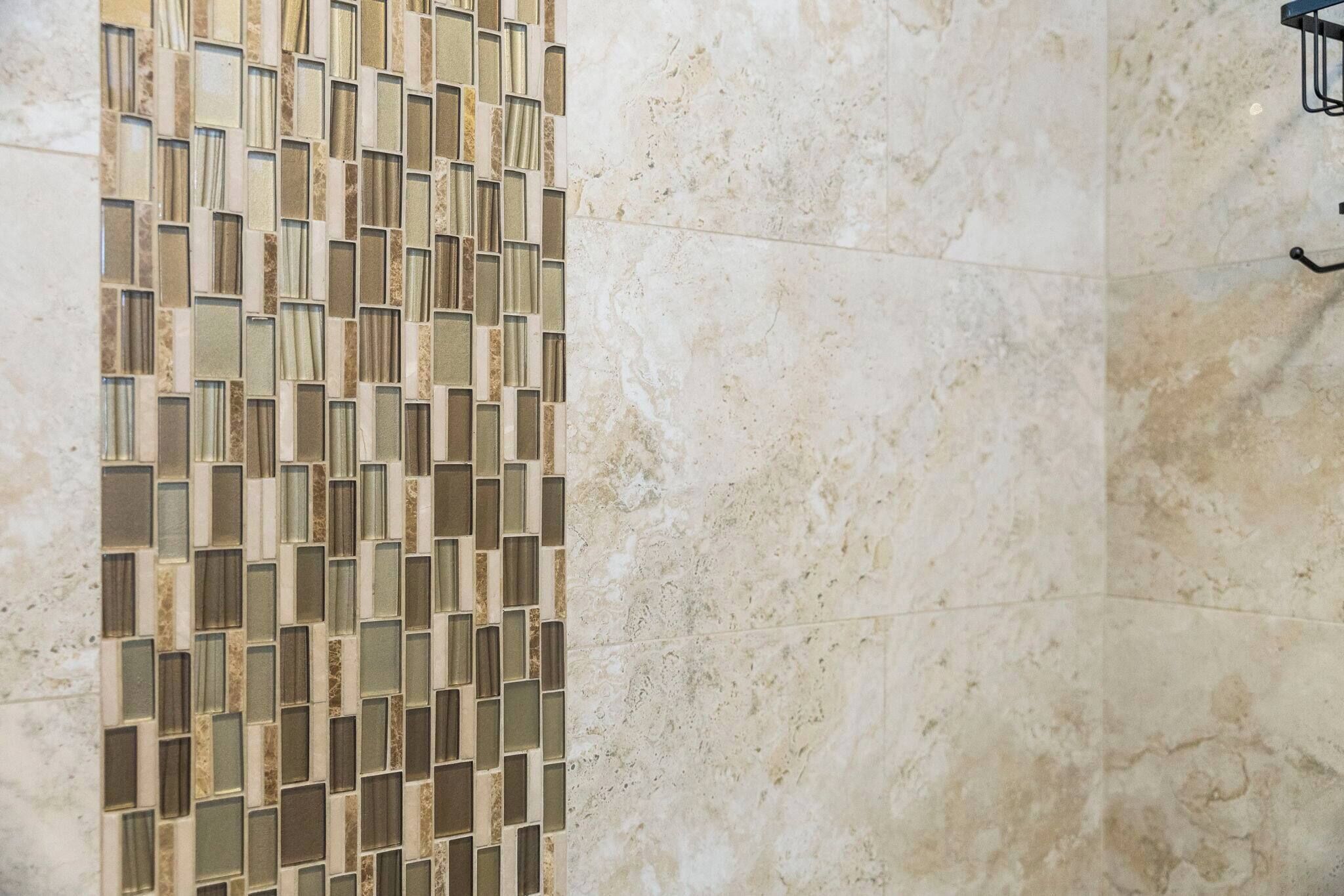 A tiled wall with a mosaic pattern.
