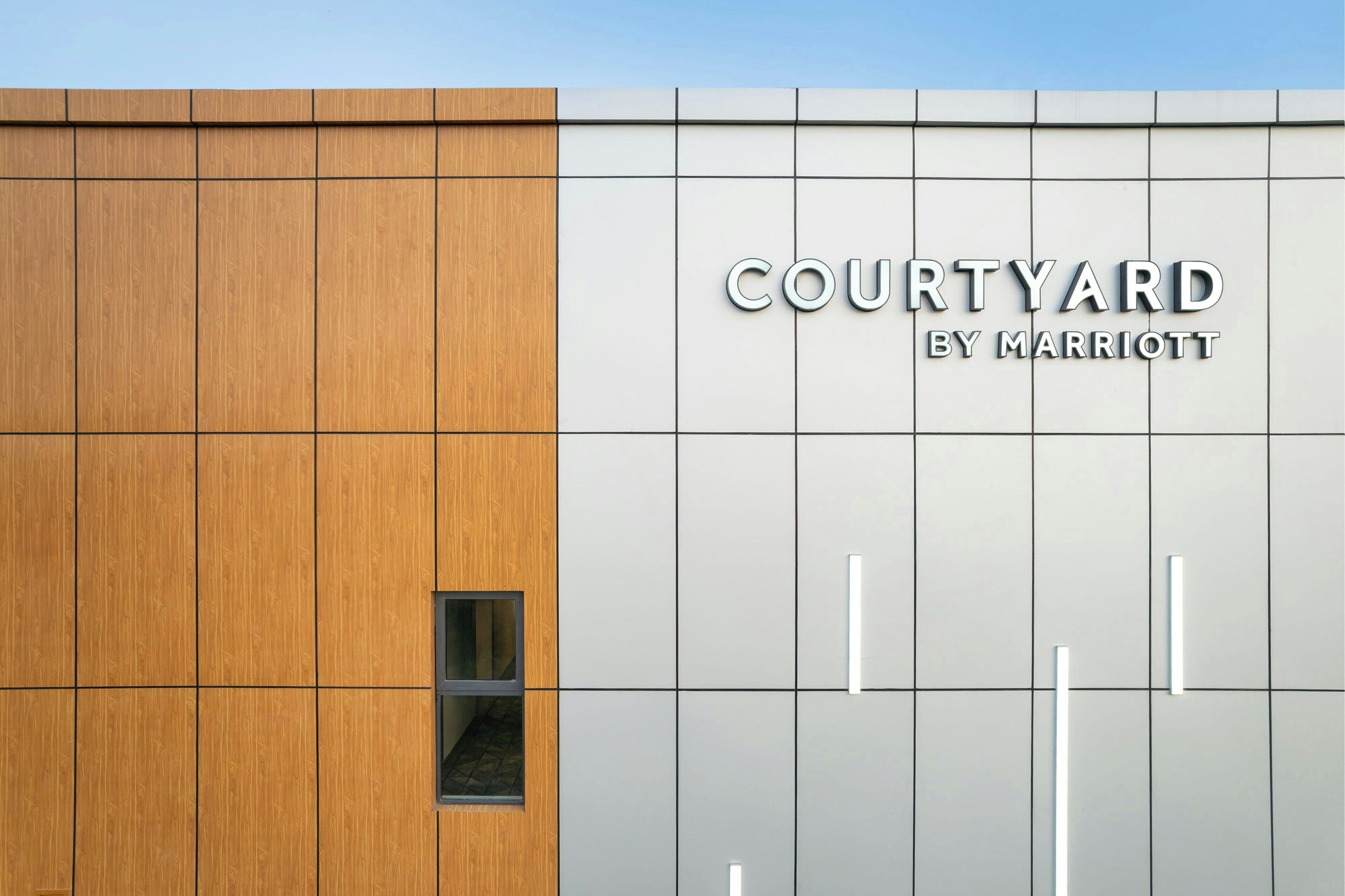 A building facade with a sign reading "COURTYARD BY MARRIOTT".