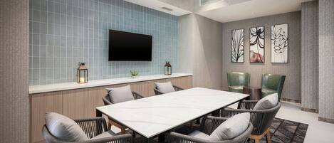 Una sala de reuniones moderna con una amplia mesa, seis sillas, un televisor de pantalla plana y decoración en la pared.