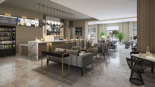 A modern hotel lobby with a marble reception desk, seating area, and a dining space. - Courtyard Cheddi Jagan International Airport, Guyana (Timehri)