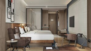 A modern hotel room with a large bed, a sofa, a small table, and a TV. - Four Points By Sheraton Ji’An (Ji'an)