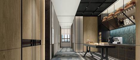 A modern kitchen with a long counter, wooden cabinets, and a patterned floor.
