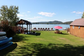 A lakeside property with a gazebo, outdoor seating, and a view of the lake. - Polar Bear Cabin at The Bears Cottages (Inlet)
