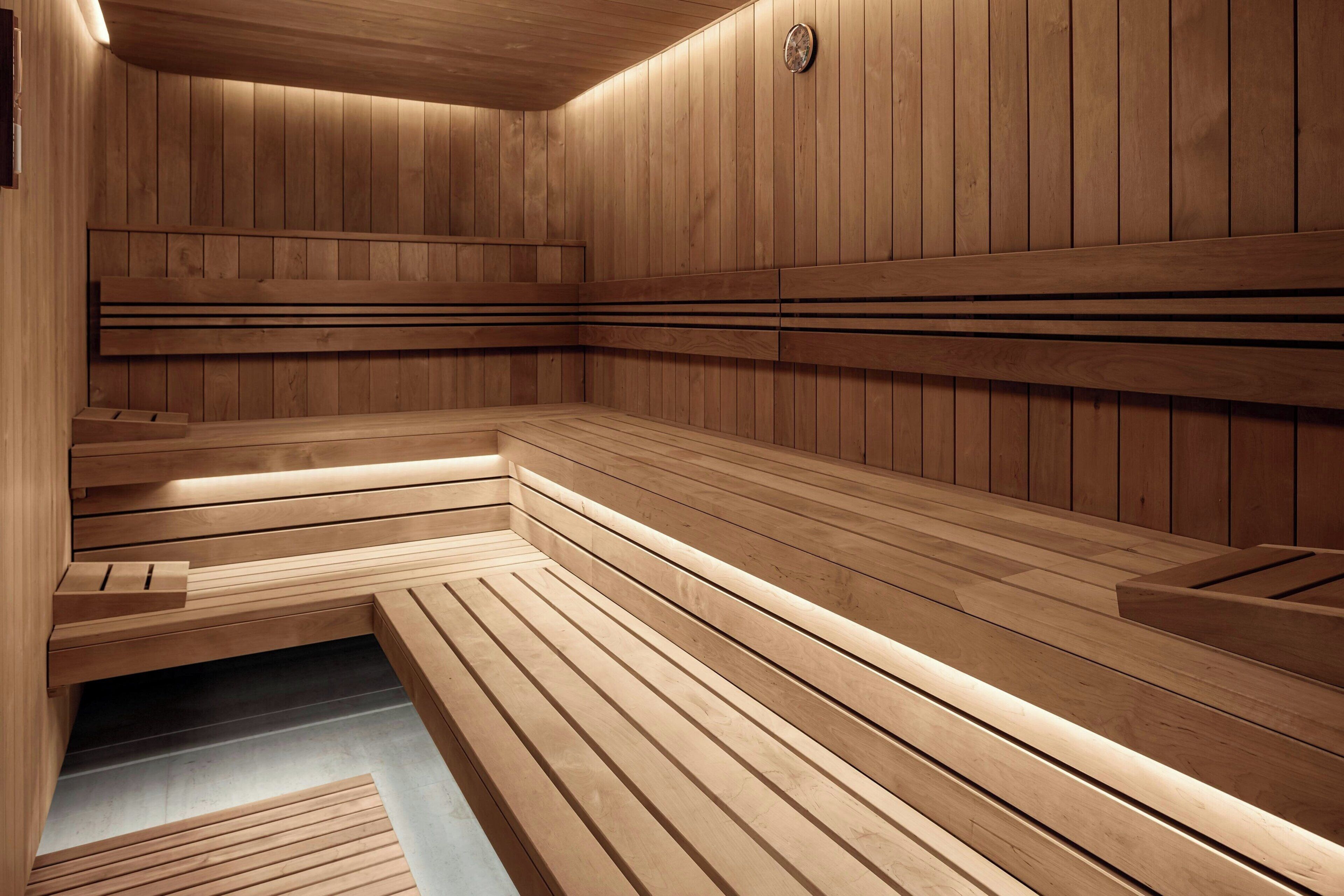 A sauna with wooden benches and a sloped floor.
