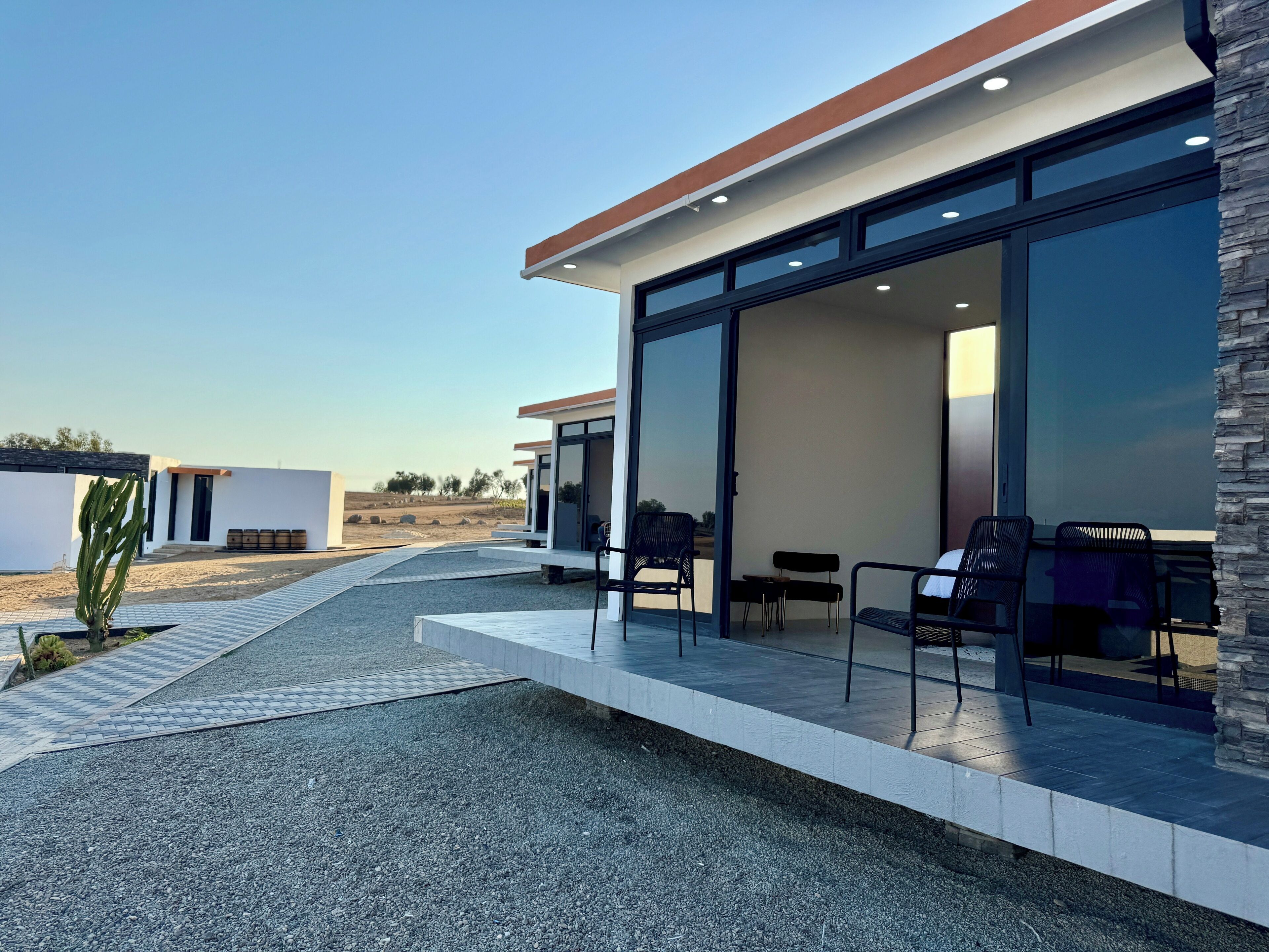 A modern building with a patio area featuring outdoor seating.