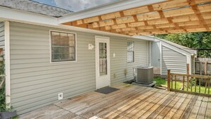 A single-story house with a covered patio area, a front door, and an air conditioning unit.