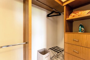 A wooden wardrobe with a hanging rack and a shelf with an iron and a patterned cloth. - Centric Apt in Downtown - Rooftop Pool - Terrace (Cabo San Lucas)