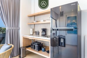 Fridge, microwave, coffee/tea maker, cookware/dishes/utensils