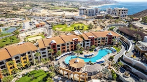 A resort with a central pool, multiple buildings, and a golf course. - Splendid 2BR House with Ocean View in Cabo (Cabo San Lucas)