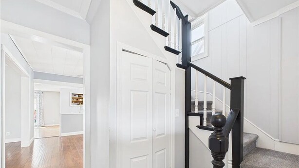 A staircase with a black handrail and white walls. - Geneva Getaway for Wine, Weddings & Lake Days (Geneva)