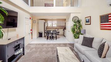 A multi-level apartment with a dining area, kitchen, living room, and a balcony.