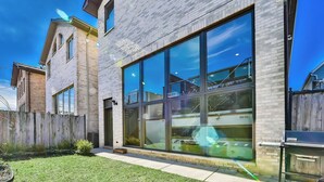A modern building with large windows and a brick facade. - 6 BDRM/ 6 BATH LUX Avondale Home, Sleeps 15, Rooftop Deck & 2 Car Garage! (Chicago)