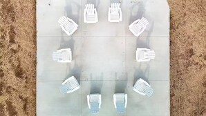 A tiled floor with white chairs arranged in a circular pattern. - Brillion 2‑Bedroom Suite w/ Full Kitchen Near Ariens – Unit #1 (Brillion)