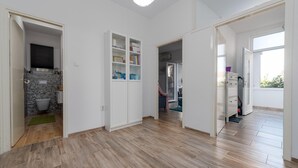 A spacious hallway with wooden flooring, white walls, and open doors leading to different rooms. - Beautiful apartment in Preko with house sea view (Preko)