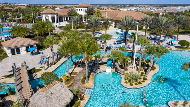 A resort with multiple swimming pools, palm trees, and a thatched-roof structure. - 4BR Home with Private Pool & Disney Themes (DAVENPORT)
