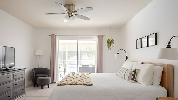 A hotel room with a bed, a desk, a chair, a television, a ceiling fan, and a window with curtains. - Beautiful Retreat *5min -> Disney *Pool *King Bed (Kissimmee)