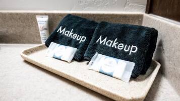 Zwei dunkelblaue Handtücher mit dem Aufdruck 'Makeup', platziert auf einer beigen Ablagefläche.