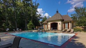 A swimming pool with lounge chairs and a building with a tiled roof. - The Adele @ Oxford Farms- Tucked off South Lamar! Two Miles from The Square! (Oxford)