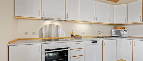Fridge, stovetop, dishwasher, coffee/tea maker