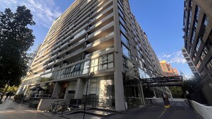 A modern high-rise building with multiple balconies and large windows. - Comfortable, equipped stay in a prime area (Las Condes)