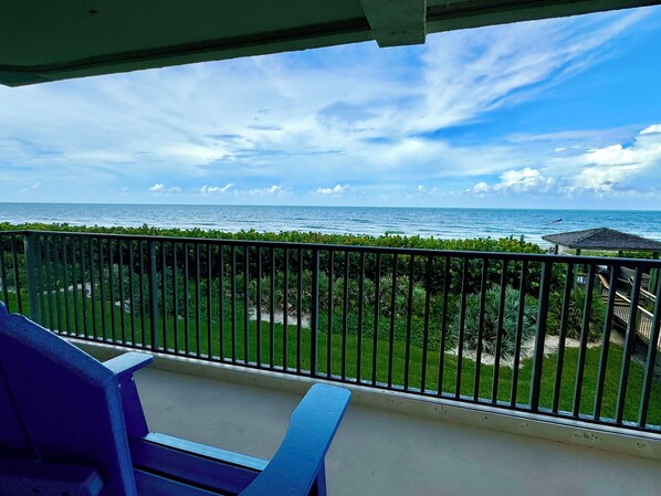 A balcony with a view of the ocean and a grassy area. - Spacious 2/2 Oceanfront Corner Unit with Incredible Direct Beach Views & Access! (Jensen Beach)