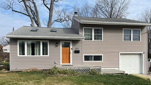 A two-story house with a front porch, a garage, and a number '131' on the door. - Welcome FIFA! Nice 4-BR house, EZ Access to stadiums, PHL Airport, I95 & Transit (Claymont)