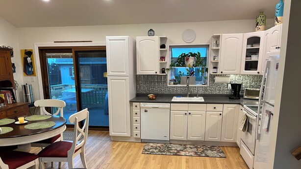 A modern kitchen with white cabinets, a dishwasher, a stove, and a sink. - Welcome FIFA! Nice 4-BR house, EZ Access to stadiums, PHL Airport, I95 & Transit (Claymont)