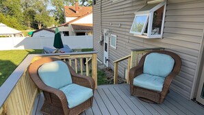 A wooden deck with two wicker chairs and a small table. - Welcome FIFA! Nice 4-BR house, EZ Access to stadiums, PHL Airport, I95 & Transit (Claymont)