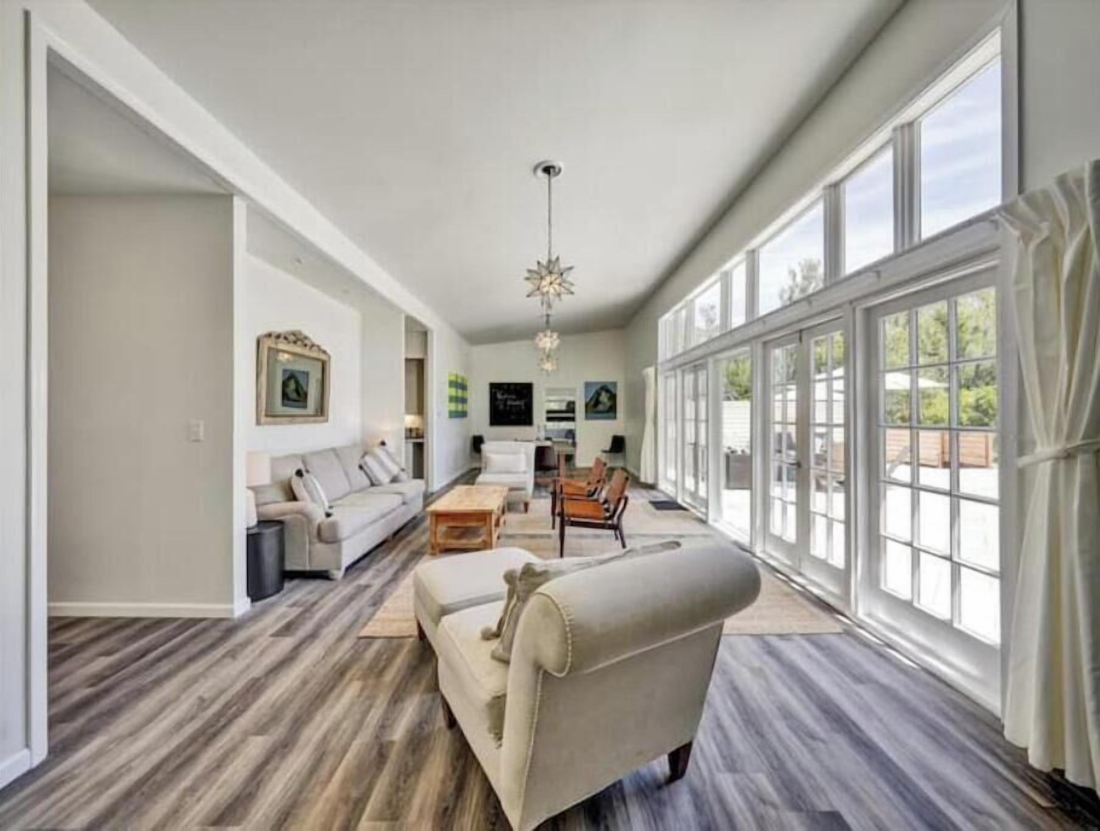 Open living with dining, piano, views, and patio access through glass doors.