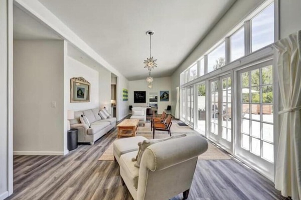 Open living with dining, piano, views, and patio access through glass doors.