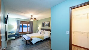 A bedroom with a bed, a desk, a chair, a ceiling fan, and a window with curtains. - Dockside Daze | Lakefront + Hot Tub | Sleeps 12, Stellar Sunsets (Bristol)
